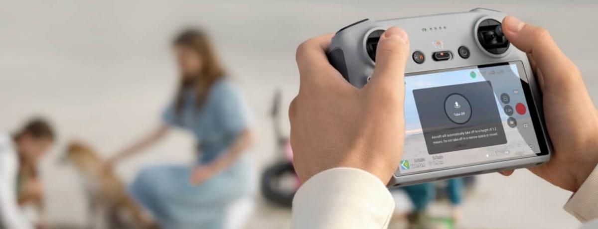 Man holds remote of FPV drone