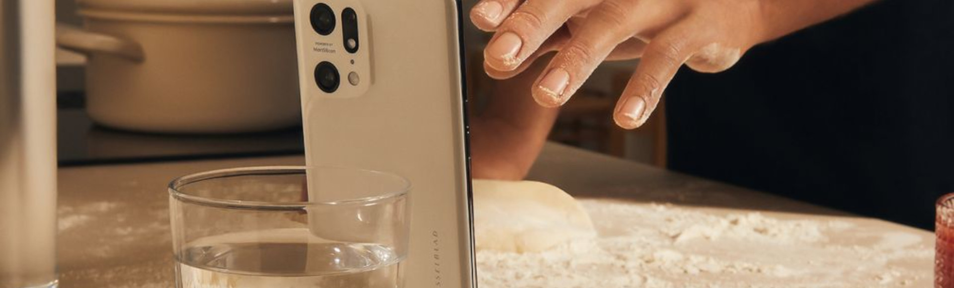 Oppo X5 Pro at the kitchen along with glass of water and floor